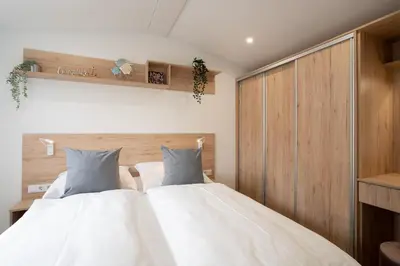 Ein Bett oder Betten in einem Zimmer der Unterkunft Ostseecamp Ferienhaus 