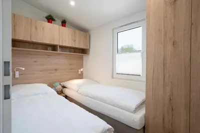 Ein Bett oder Betten in einem Zimmer der Unterkunft Ostseecamp Ferienhaus 