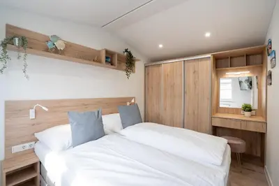 Ein Bett oder Betten in einem Zimmer der Unterkunft Ostseecamp Ferienhaus 