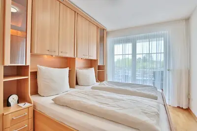 Ein Bett oder Betten in einem Zimmer der Unterkunft Stranddomizil Stranddomizil Appartement 7