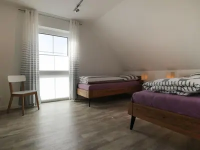 Ein Bett oder Betten in einem Zimmer der Unterkunft Kapitänshaus