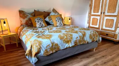 Ein Bett oder Betten in einem Zimmer der Unterkunft Sachsenhof Villa Kunterbunt