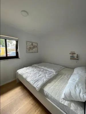Ein Bett oder Betten in einem Zimmer der Unterkunft Haffkrug Beach Bungalow