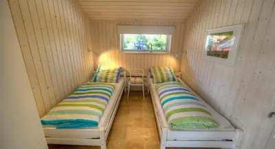 Ein Bett oder Betten in einem Zimmer der Unterkunft Timmenhus - Ferienhäuser am Feldrand