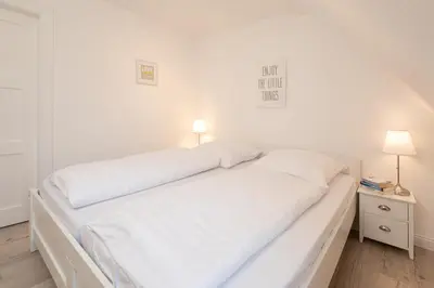 Ein Bett oder Betten in einem Zimmer der Unterkunft Meeresliebling