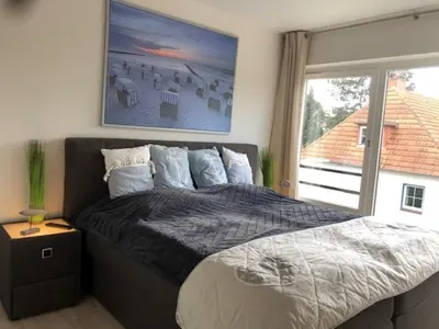 Ein Bett oder Betten in einem Zimmer der Unterkunft StrandMÖWE Scharbeutz