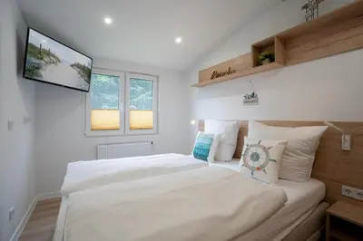 Ein Bett oder Betten in einem Zimmer der Unterkunft Ostseecamp Ferienhaus 
