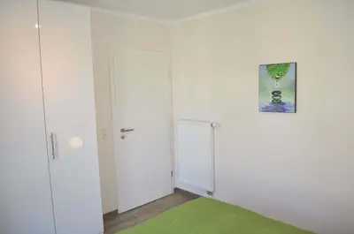Ein Bett oder Betten in einem Zimmer der Unterkunft Domizil am Meer Nr 15 Ferienwohnung Meerblick