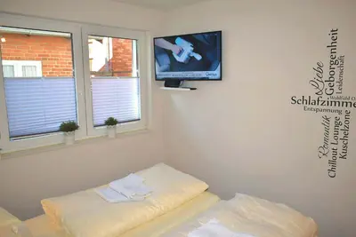 Ein Bett oder Betten in einem Zimmer der Unterkunft Hansehuus Ferienwohnung