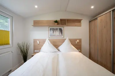 Ein Bett oder Betten in einem Zimmer der Unterkunft Ostseecamp Ferienhaus 
