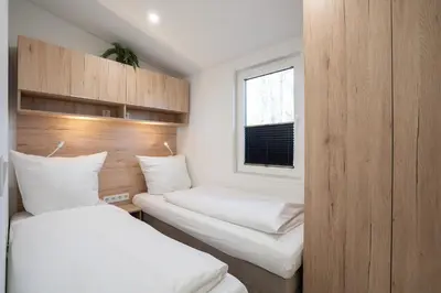 Ein Bett oder Betten in einem Zimmer der Unterkunft Ostseecamp Ferienhaus 