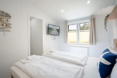 Ein Bett oder Betten in einem Zimmer der Unterkunft Ostseecamp Muscheltraum