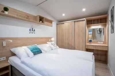 Ein Bett oder Betten in einem Zimmer der Unterkunft Ostseecamp Ferienhaus 