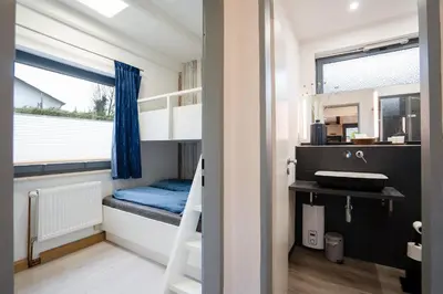 Ein Bett oder Betten in einem Zimmer der Unterkunft AMW8d Ferienhaus Moin