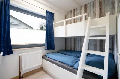 Ein Bett oder Betten in einem Zimmer der Unterkunft AMW8d Ferienhaus Moin