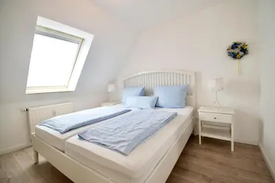 Ein Bett oder Betten in einem Zimmer der Unterkunft Villa Wilhelma Apartment A2 1 OG