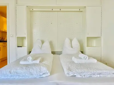 Ein Bett oder Betten in einem Zimmer der Unterkunft Strand Suite