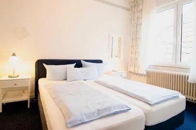 Ein Bett oder Betten in einem Zimmer der Unterkunft Villa Wilhelma Strandallee 146 Villa Wilhelma Apartment 6