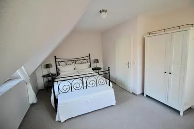 Ein Bett oder Betten in einem Zimmer der Unterkunft Hamptons House