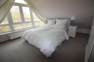Ein Bett oder Betten in einem Zimmer der Unterkunft Hamptons House