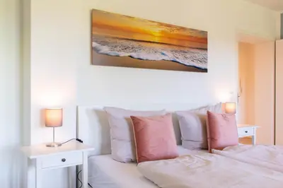 Ein Bett oder Betten in einem Zimmer der Unterkunft Ferienwohnung Küstenschatz - Timmendorfer Strand