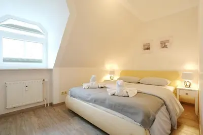 Ein Bett oder Betten in einem Zimmer der Unterkunft Am Rosenhain 14 Appartement 4