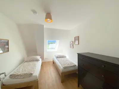Ein Bett oder Betten in einem Zimmer der Unterkunft Timmenhus - neue Ferienwohnungen im historischen Bauernhaus