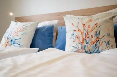 Ein Bett oder Betten in einem Zimmer der Unterkunft Ostseecamp Ferienhaus 