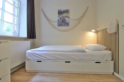 Ein Bett oder Betten in einem Zimmer der Unterkunft Whg Wismar, Groß Schwansee