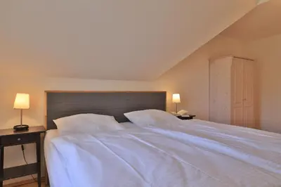 Ein Bett oder Betten in einem Zimmer der Unterkunft Wellenreiter Ferienhaus