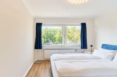 Ein Bett oder Betten in einem Zimmer der Unterkunft Perle Timmendorfer Strand