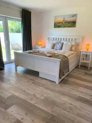 Ein Bett oder Betten in einem Zimmer der Unterkunft Sonnengarten Travemünde