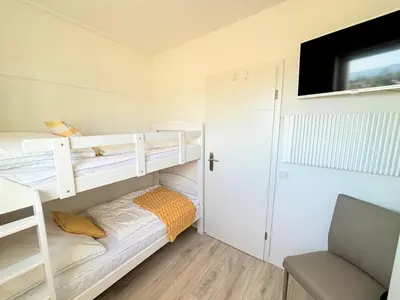 Ein Bett oder Betten in einem Zimmer der Unterkunft Ferienpark Sierksdorf Horizont