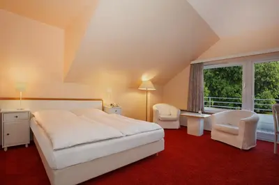 Ein Bett oder Betten in einem Zimmer der Unterkunft Gästehaus Kaiserhof Lübeck