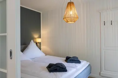 Ein Bett oder Betten in einem Zimmer der Unterkunft Haffperle - Meerblau