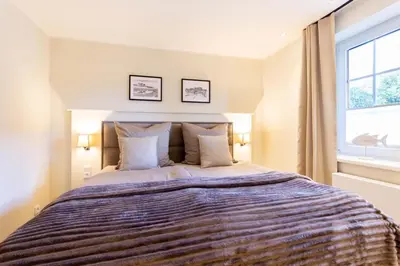 Ein Bett oder Betten in einem Zimmer der Unterkunft Ferienwohnung Neptuns Garden Haffkrug