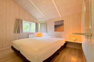 Ein Bett oder Betten in einem Zimmer der Unterkunft Strandblick - Dorf 1 Ferienhaus 10