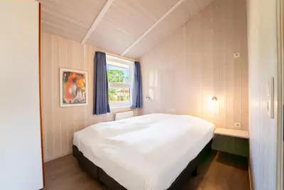 Ein Bett oder Betten in einem Zimmer der Unterkunft Strandblick - Dorf 1 Ferienhaus 09