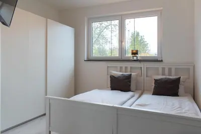 Ein Bett oder Betten in einem Zimmer der Unterkunft Ferienhaus Admirals Huus Niendorf