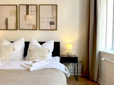 Ein Bett oder Betten in einem Zimmer der Unterkunft Moderne Ambient Apartments direkt in der Lübecker Altstadt