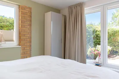 Ein Bett oder Betten in einem Zimmer der Unterkunft Ferienhaus Haffwiese - Haffkrug