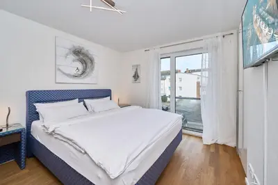Ein Bett oder Betten in einem Zimmer der Unterkunft Moin am Meer! Hansastr 5 a