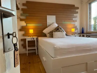 Ein Bett oder Betten in einem Zimmer der Unterkunft Geibel-Haus Fewo Horizont bis 10 Personen