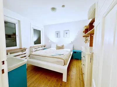 Ein Bett oder Betten in einem Zimmer der Unterkunft Geibel-Haus Fewo Horizont bis 10 Personen