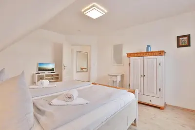 Ein Bett oder Betten in einem Zimmer der Unterkunft Das Friesenhaus