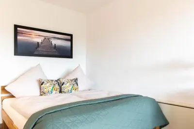 Ein Bett oder Betten in einem Zimmer der Unterkunft Ferienwohnung Residenz App. 612 Timmendorfer Strand