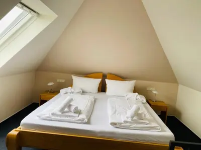 Ein Bett oder Betten in einem Zimmer der Unterkunft Strandvilla Haffkrug Apartment Albatros