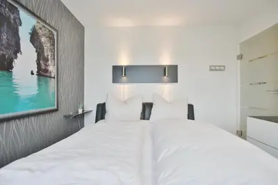 Ein Bett oder Betten in einem Zimmer der Unterkunft Strandschlößchen Strandschlösschen Appartement 27