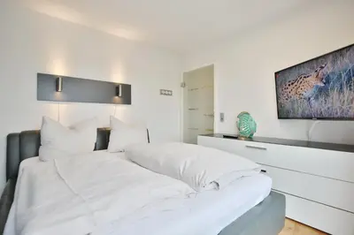 Ein Bett oder Betten in einem Zimmer der Unterkunft Strandschlößchen Strandschlösschen Appartement 27
