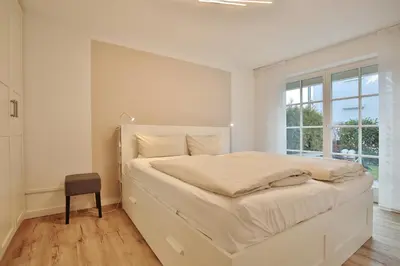 Ein Bett oder Betten in einem Zimmer der Unterkunft Haus Seerose Seerose II Appartement 11